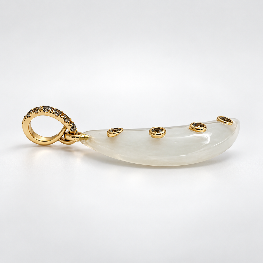Side view of a moonstone crescent moon pendant lying horizontally, showing four bezel-set blue topaz accents along the moon and a gemstone-set 14k gold bail.