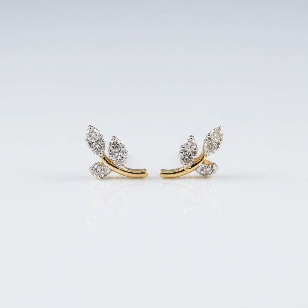 Pair of 14k solid yellow gold leaf branch stud earrings, each with three leaf shapes set with sparkling natural diamonds on a curved gold stem, shown on a soft white background.
