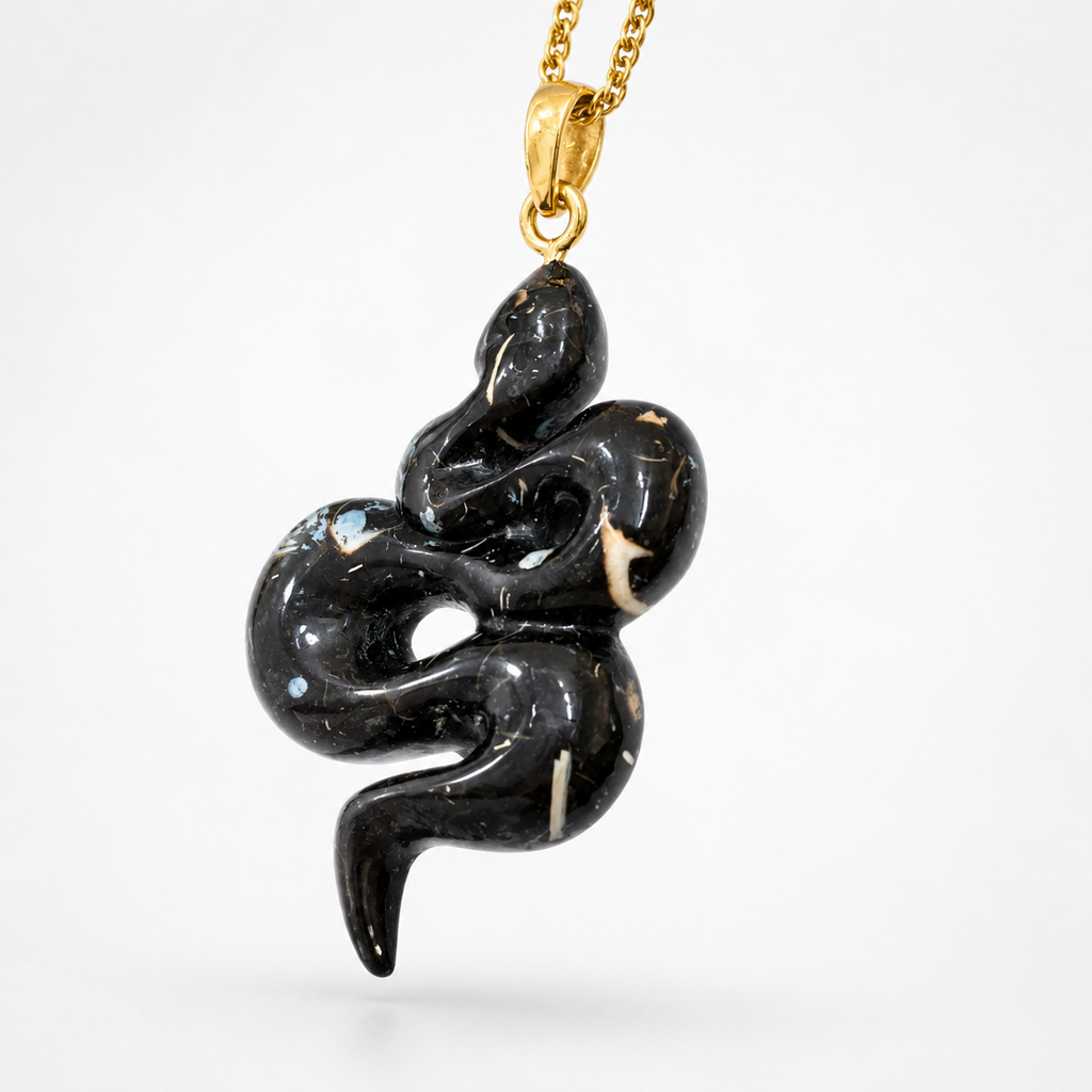 Fossilized Shell Serpent Pendant Angled View – Glossy Black Coiled Snake White Fossil Inclusions Gold
