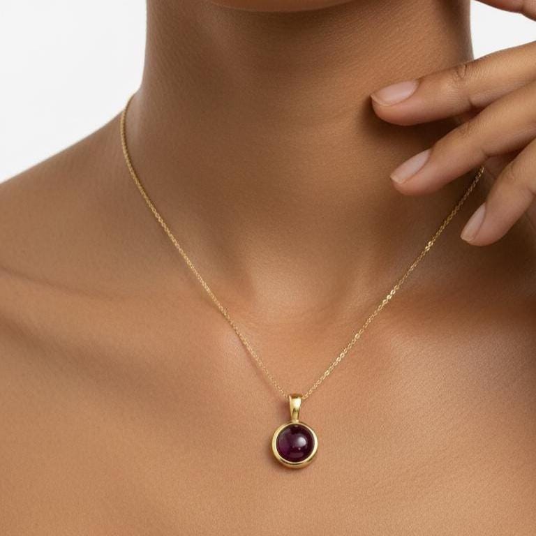 Model Wearing 14K Gold Ruby Pendant – Natural Ruby Cabochon Bezel Necklace at Collarbone
