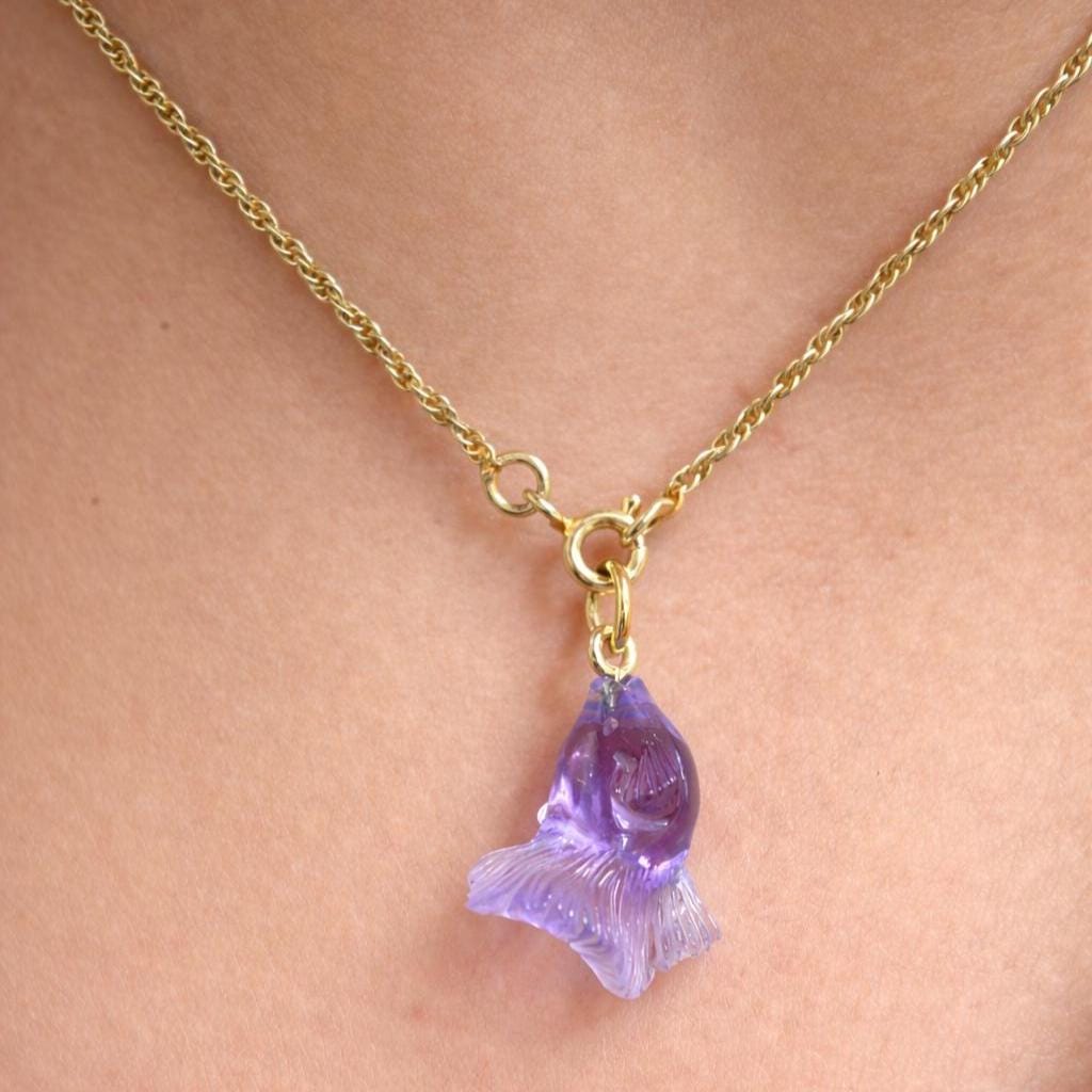 Model Wearing Amethyst Fish Pendant – Hand Carved Translucent Purple Gemstone Betta Gold Necklace
