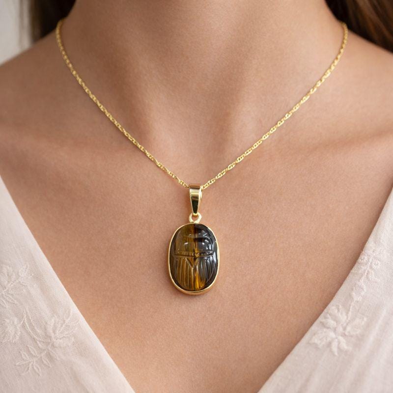 Model Wearing Tiger Eye Scarab Pendant – Carved Oval Chatoyant Gemstone Egyptian Gold Necklace
