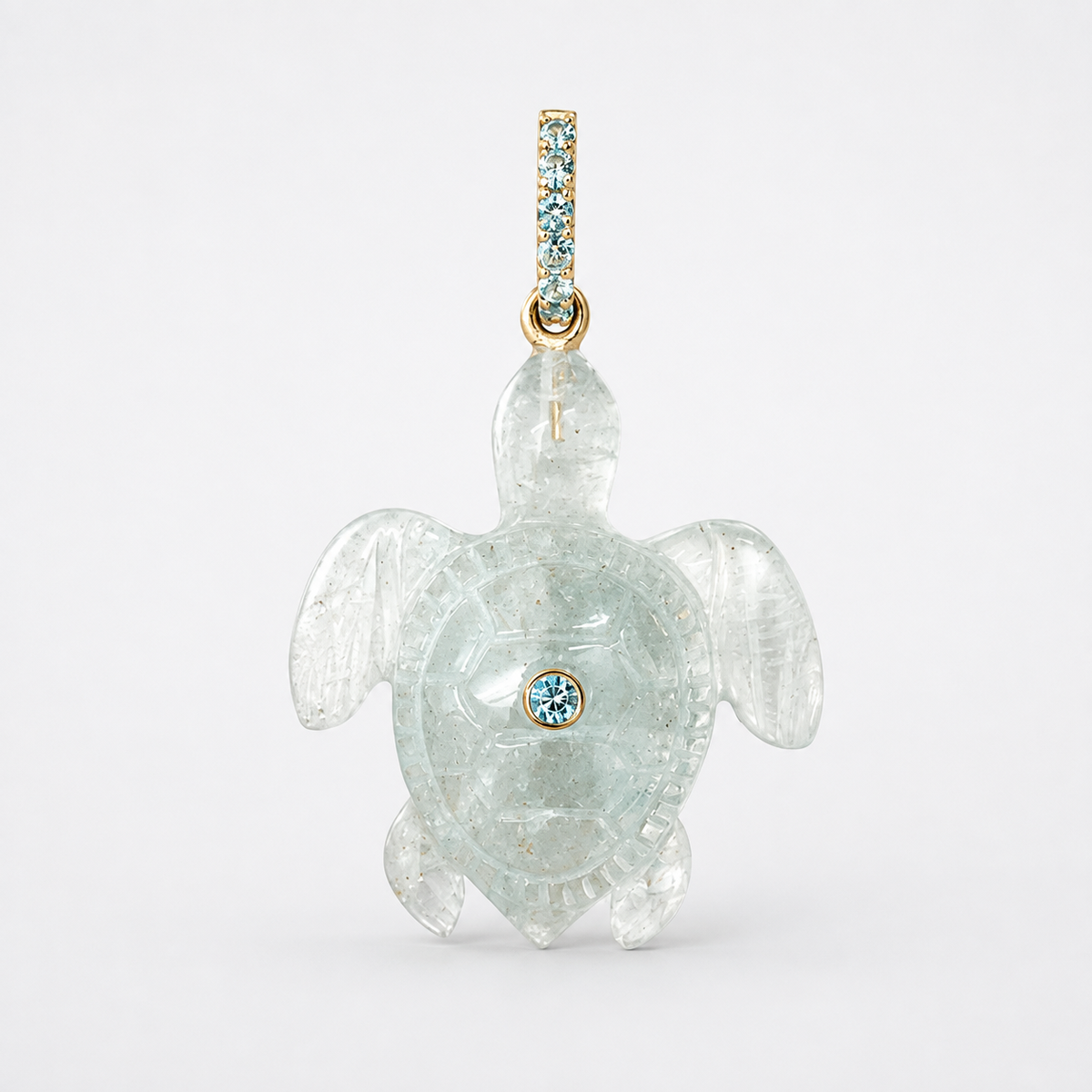 Front-facing hand-carved aquamarine sea turtle pendant with 14k yellow gold pavé bail set with Swiss blue topaz accents and bezel-set Swiss blue topaz centered on shell, translucent icy blue gemstone with symmetrical flipper spread and engraved carapace detail