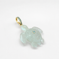 Hand-carved aquamarine sea turtle pendant with 14k yellow gold pavé ring bail set with Swiss blue topaz accents and bezel-set Swiss blue topaz, translucent pale blue gemstone with detailed shell and flipper carving