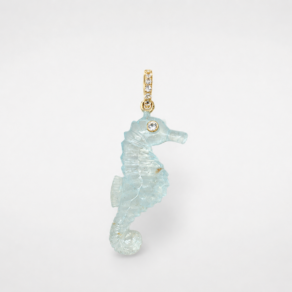 Hand-carved aquamarine seahorse pendant with 14k yellow gold pavé bail set with white topaz accents and bezel-set white topaz eye, translucent pale blue gemstone with natural inclusions