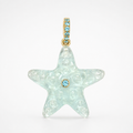 Front-facing hand-carved aquamarine starfish pendant with 14k yellow gold pavé bail set with Swiss blue topaz accents and bezel-set Swiss blue topaz center accent, translucent pale seafoam blue gemstone with raised bubble and swirl surface texture across five pointed arms